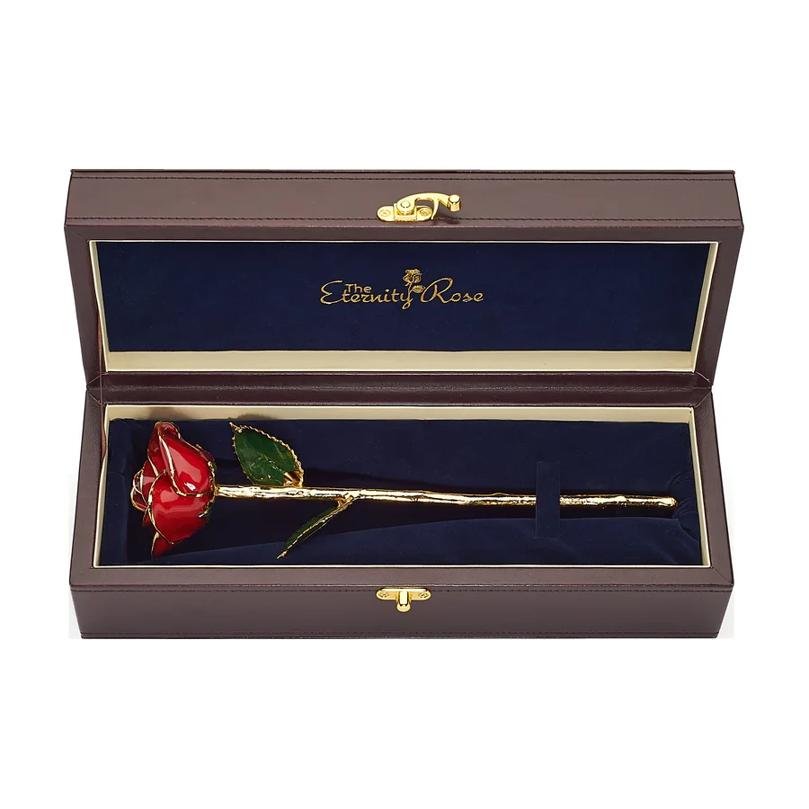 A red glazed natural rose with gold trim in its open leather presentation case